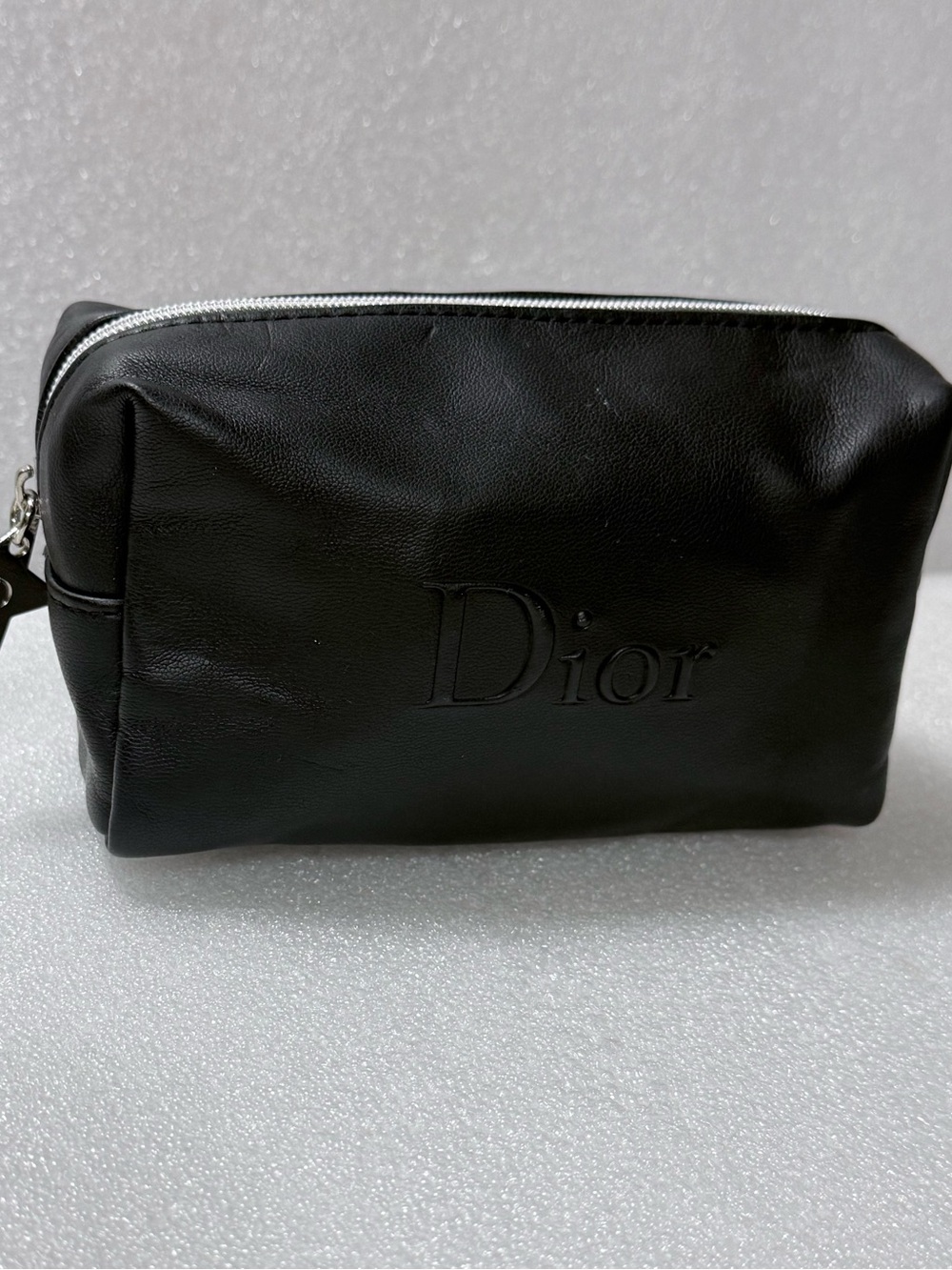 Dior makeup bag features a black exterior